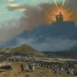 A dramatic painting depicts Moses on Mount Sinai, silhouetted against a divine light, as a vast multitude of people gather below.