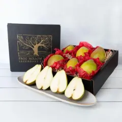 A box of pears, symbolizing longevity and abundance, sits beside a platter of halved pears.