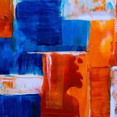 Bold strokes of blue and orange create a dynamic composition, showcasing various types of abstract art with thick impasto textures.