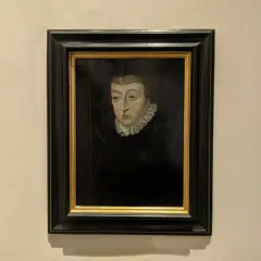 A dark portrait of Catherine de Medici, her gaze direct, framed by a ruffled collar and a dark headdress.