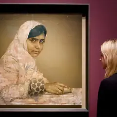 A striking **Malala Yousafzai portrait** shows her looking thoughtfully, her hands resting on a book. A woman observes the artwork.