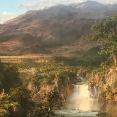 A majestic waterfall cascades through a lush valley, revealing the heart of the Andes. Snow-capped peaks loom in the distance.