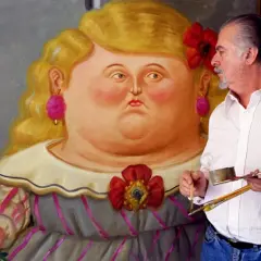 Artist Fernando Botero with a palette and brushes, standing next to a painting of a voluptuous woman in his signature style.