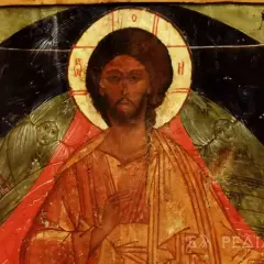 Icon of Christ the Pantocrator, with a golden halo and serene gaze, flanked by winged figures.