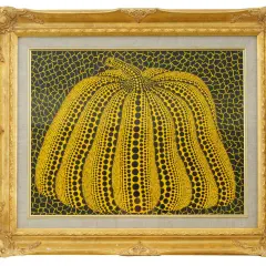 A vibrant yellow pumpkin, a signature motif of the spotted pumpkin artist, is depicted in this framed artwork. The pumpkin is covered in black dots, set against a black background with yellow netting.