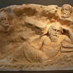 Relief sculpture depicts the wounded Philoctetes, abandoned and suffering, with two other figures observing him from above.