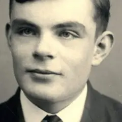 A young Alan Turing portrait, looking thoughtfully into the distance. This image captures the visionary mathematician who cracked Enigma.