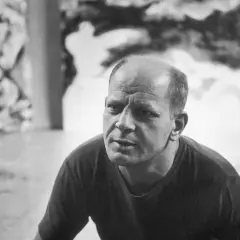A close-up of Jackson Pollock's face, his brow furrowed in thought, as if contemplating his next drip painting.
