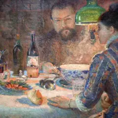 A woman in a striped dress sits at a table laden with food and drink, her gaze directed towards a man reflected in the background. This scene captures the essence of Marie Bracquemond's artistic vision.