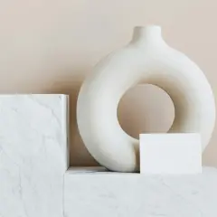 A torus-shaped vase and marble blocks, evoking minimalist famous modern art.