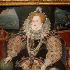 A woman gazes at a regal queen Elizabeth portrait, adorned in a jeweled gown and ruff, with a globe and crown nearby.