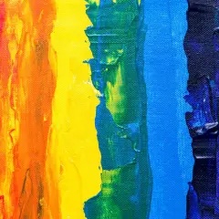 Thick, textured paint strokes in red, orange, yellow, green, blue, and pink demonstrate what is color theory in art, showing how colors interact.