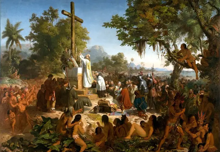 A priest leads a mass before a cross, surrounded by indigenous people and European explorers. This historical art in Brazil depicts a pivotal moment.