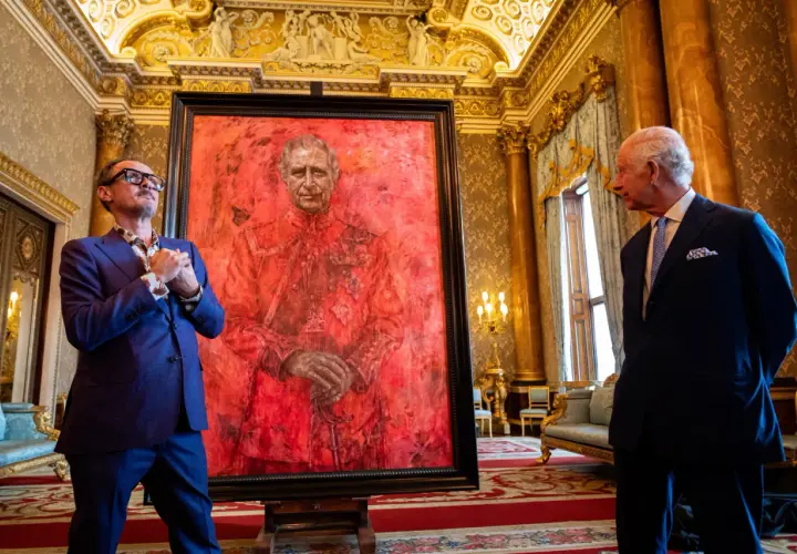 Artist and King Charles III stand by a striking red portrait. This artwork is one of what are some ways the king's portrait was used?