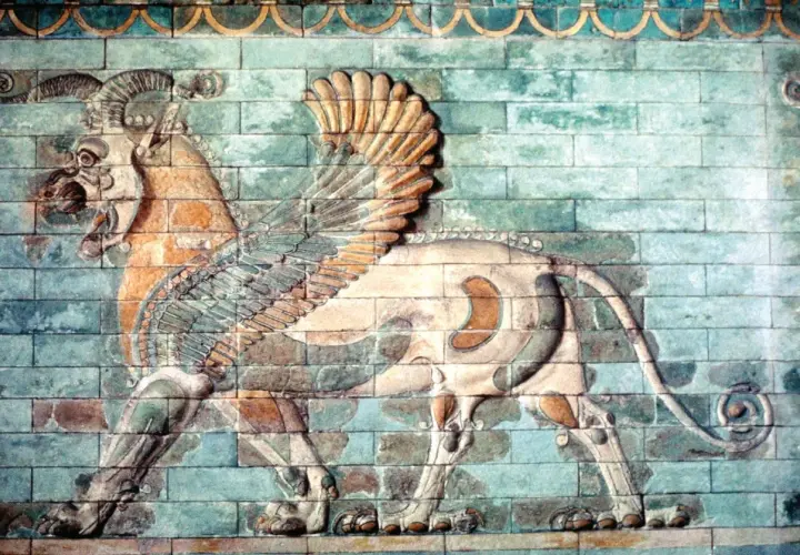 A winged lion with ram's horns, a magnificent example of ancient Iranian art, strides across a wall of glazed bricks.