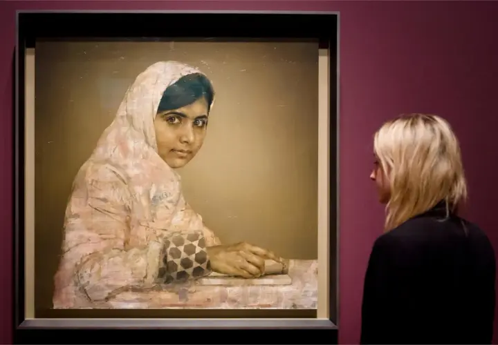A striking **Malala Yousafzai portrait** shows her looking thoughtfully, her hands resting on a book. A woman observes the artwork.