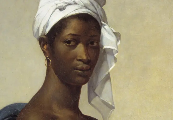 A striking portrait of Madeleine, her gaze direct, a white turban framing her face, and a gold hoop earring adorning her ear.