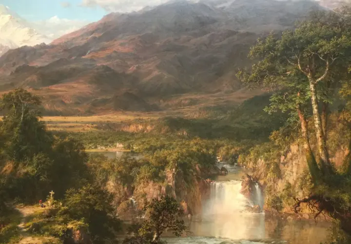 A majestic waterfall cascades through a lush valley, revealing the heart of the Andes. Snow-capped peaks loom in the distance.