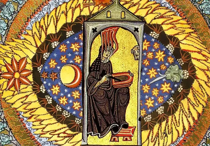 Vivid Hildegard of Bingen art depicts a woman in a dark robe, writing in a book, surrounded by celestial bodies and fiery sun rays.
