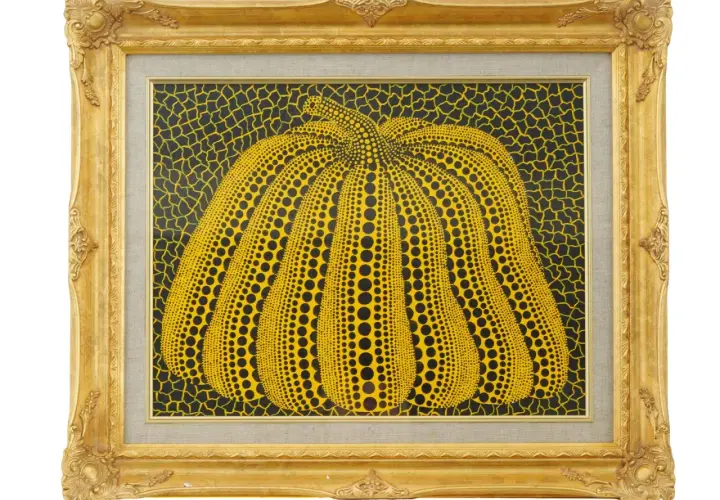 A vibrant yellow pumpkin, a signature motif of the spotted pumpkin artist, is depicted in this framed artwork. The pumpkin is covered in black dots, set against a black background with yellow netting.