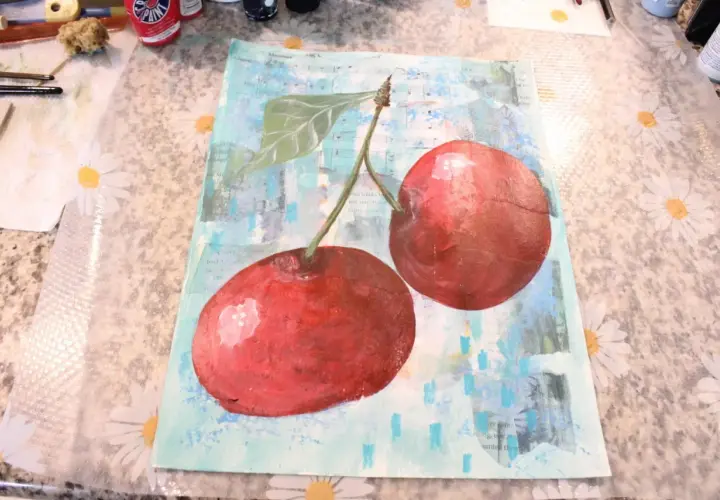 A vibrant collage and painting features two juicy cherries against a background of sheet music and abstract blue strokes.