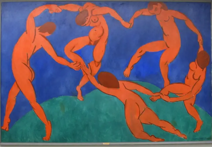 Five nude figures dance in a circle against a vibrant blue background, a signature style of Fauvism artists.