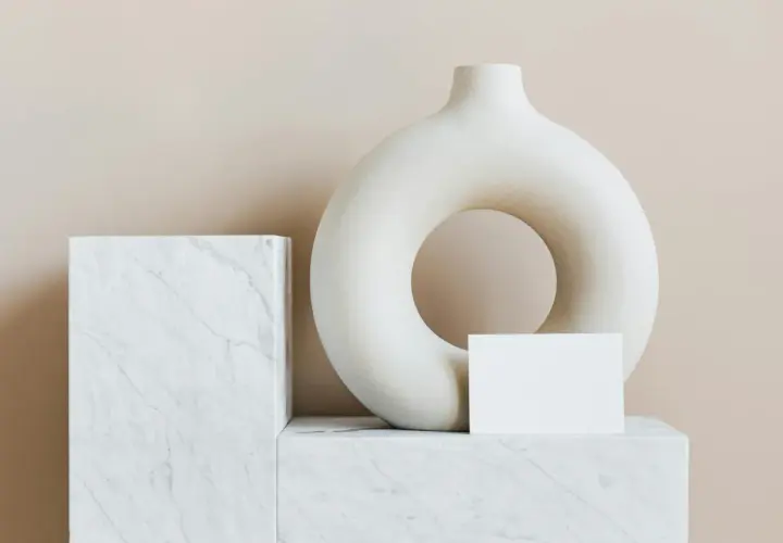A torus-shaped vase and marble blocks, evoking minimalist famous modern art.