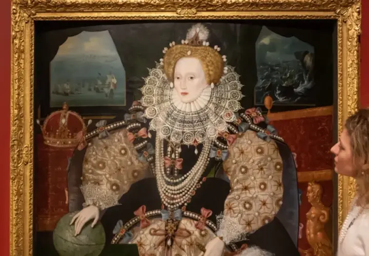 A woman gazes at a regal queen Elizabeth portrait, adorned in a jeweled gown and ruff, with a globe and crown nearby.