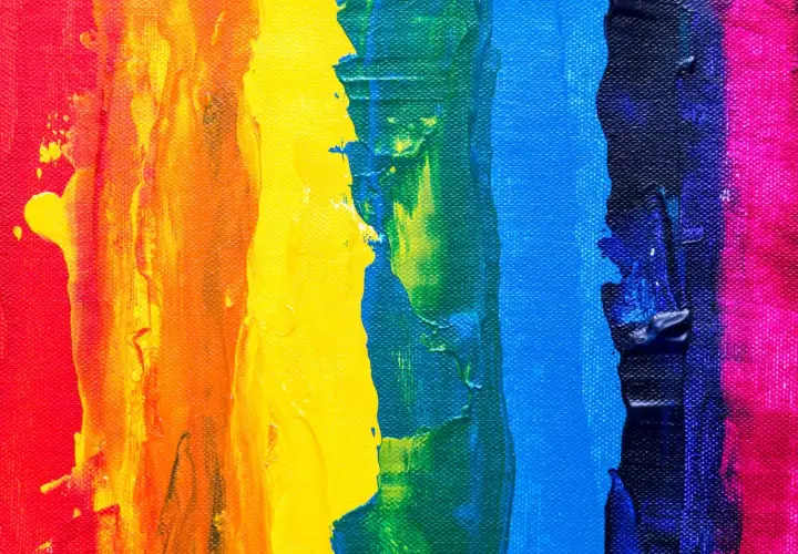 Thick, textured paint strokes in red, orange, yellow, green, blue, and pink demonstrate what is color theory in art, showing how colors interact.