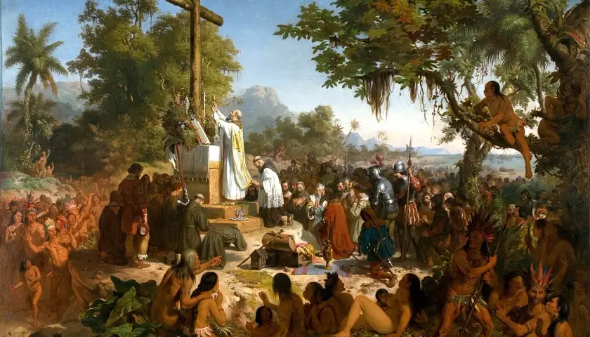 A priest leads a mass before a cross, surrounded by indigenous people and European explorers. This historical art in Brazil depicts a pivotal moment.