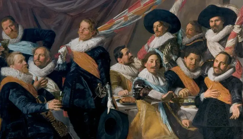 A group of men in 17th-century attire, including the laughing cavalier, gather around a table.