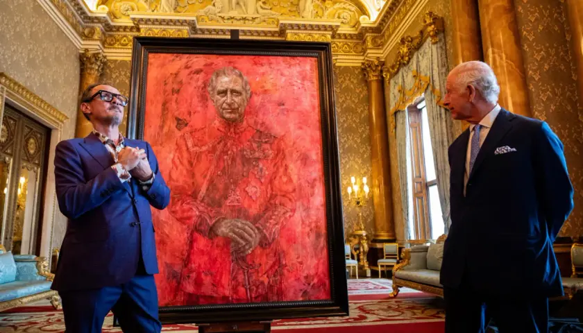Artist and King Charles III stand by a striking red portrait. This artwork is one of what are some ways the king's portrait was used?