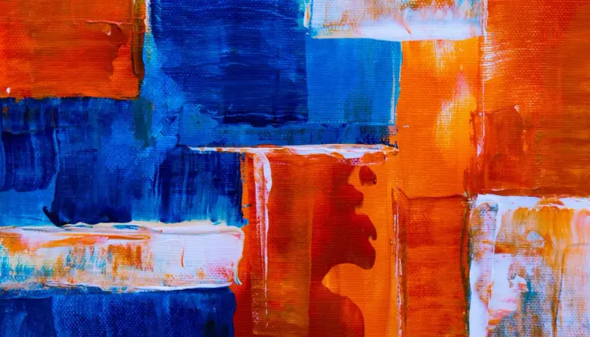 Bold strokes of blue and orange create a dynamic composition, showcasing various types of abstract art with thick impasto textures.
