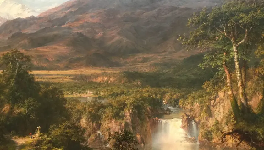 A majestic waterfall cascades through a lush valley, revealing the heart of the Andes. Snow-capped peaks loom in the distance.