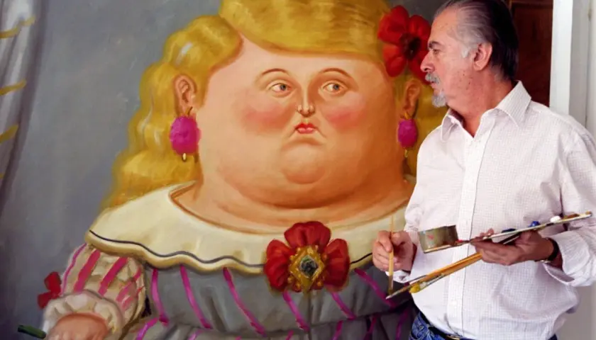 Artist Fernando Botero with a palette and brushes, standing next to a painting of a voluptuous woman in his signature style.