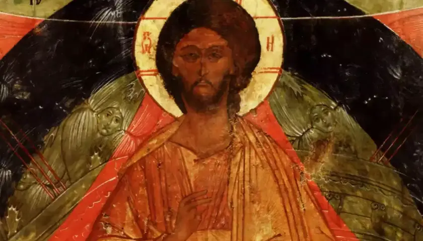 Icon of Christ the Pantocrator, with a golden halo and serene gaze, flanked by winged figures.