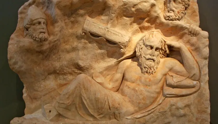 Relief sculpture depicts the wounded Philoctetes, abandoned and suffering, with two other figures observing him from above.