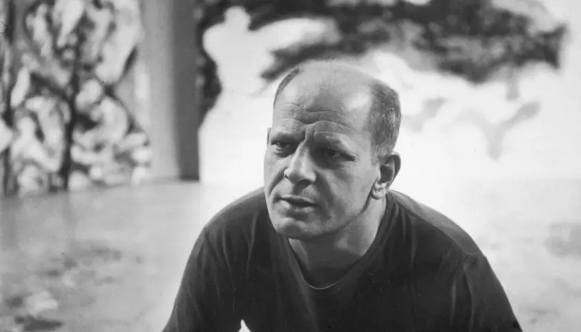 A close-up of Jackson Pollock's face, his brow furrowed in thought, as if contemplating his next drip painting.