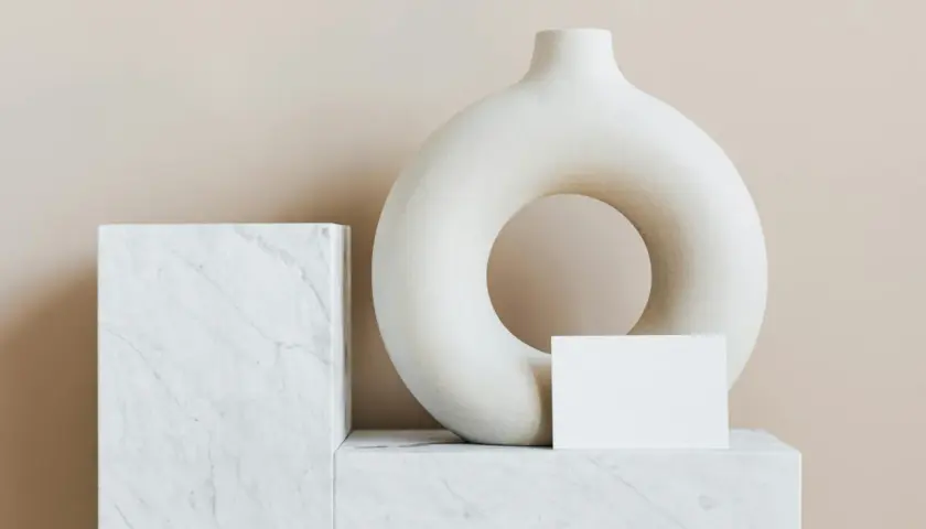 A torus-shaped vase and marble blocks, evoking minimalist famous modern art.