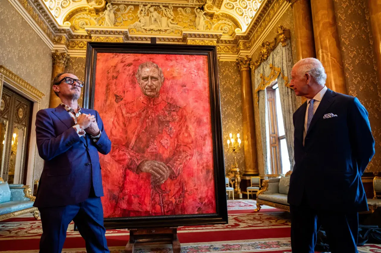 Artist and King Charles III stand by a striking red portrait. This artwork is one of what are some ways the king's portrait was used?