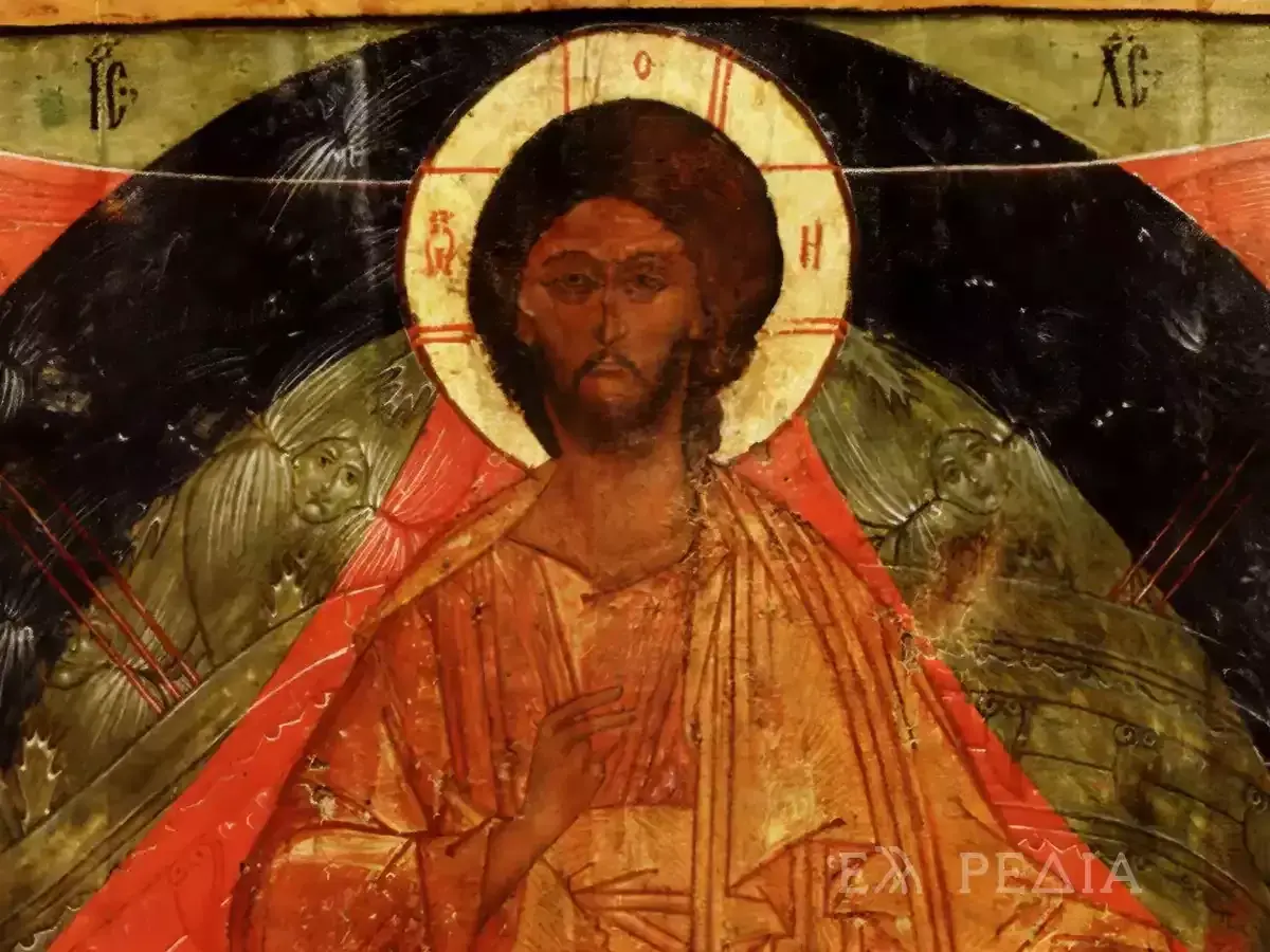 Icon of Christ the Pantocrator, with a golden halo and serene gaze, flanked by winged figures.