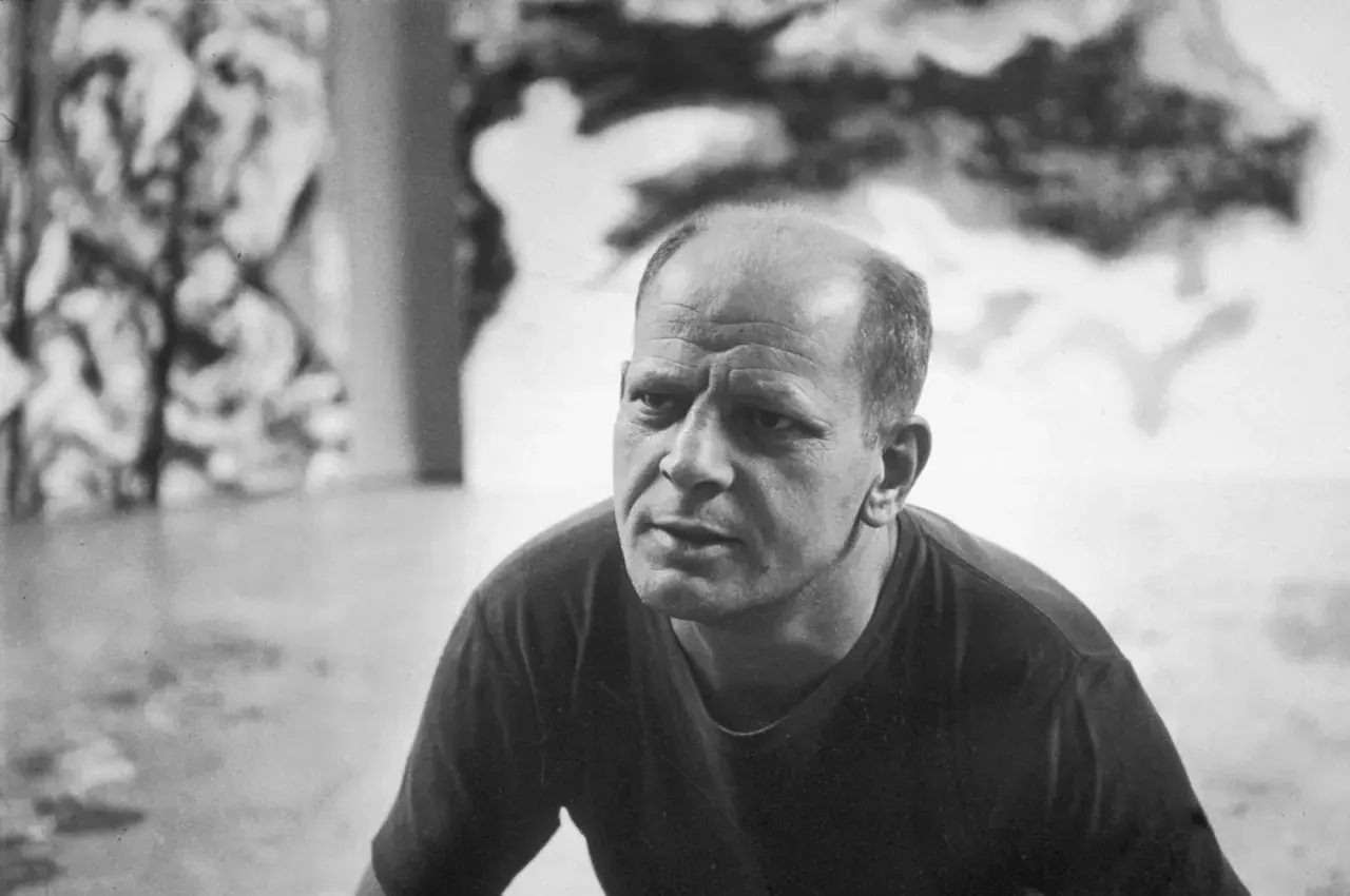A close-up of Jackson Pollock's face, his brow furrowed in thought, as if contemplating his next drip painting.