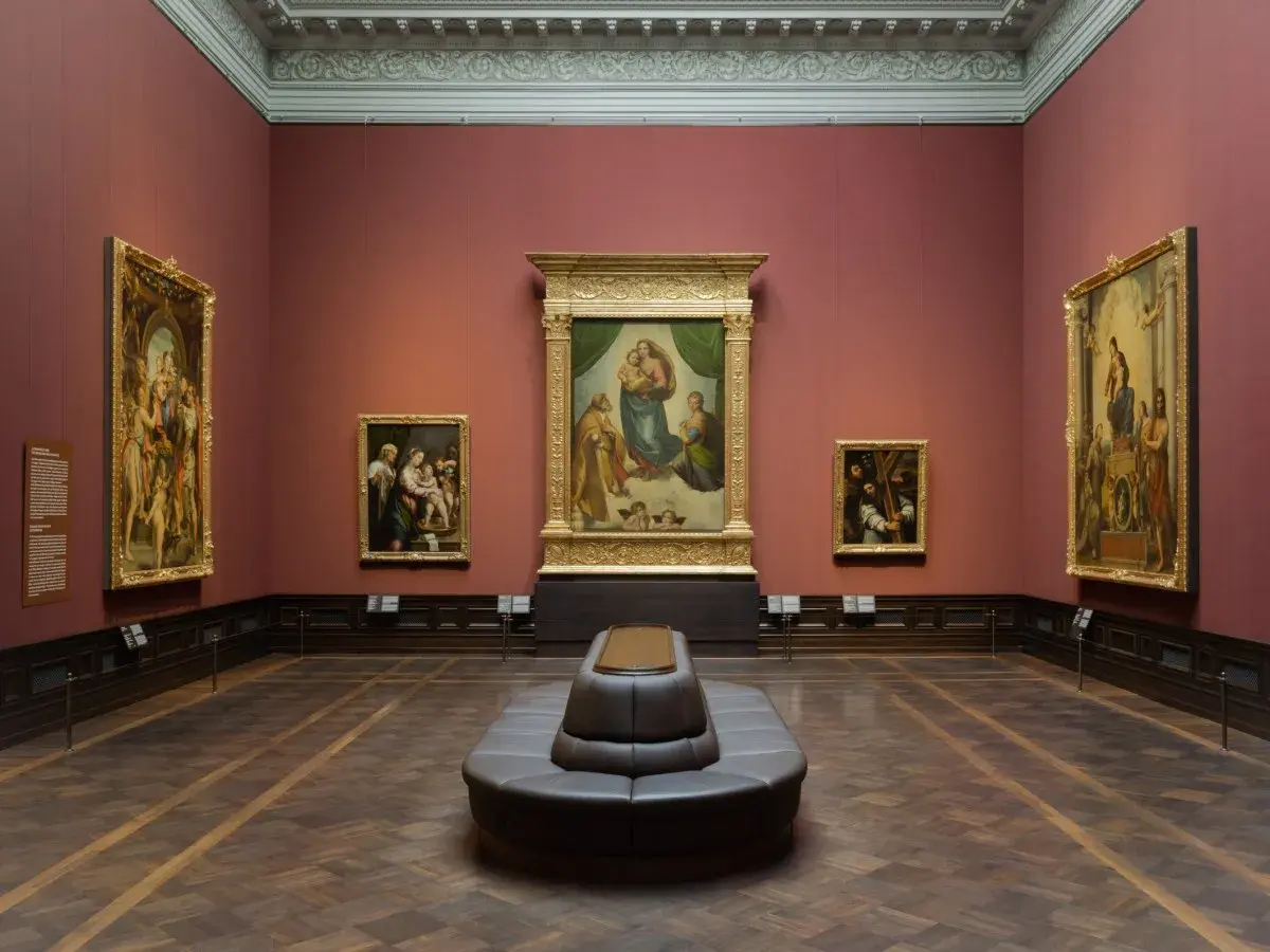 A museum gallery with the Raphael Sistine Madonna as the centerpiece, surrounded by other Renaissance paintings.