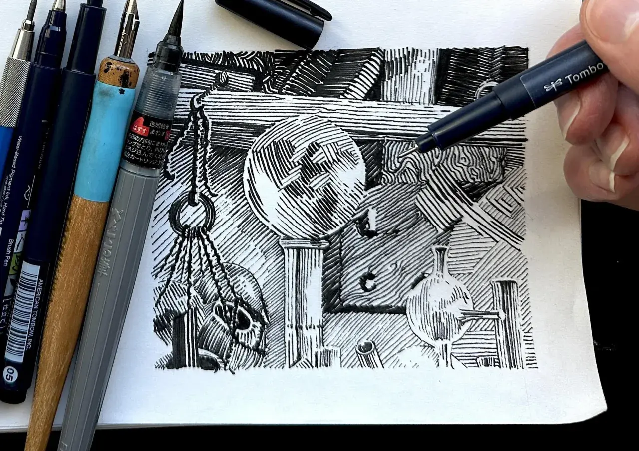 A hand uses a Tombow pen to add detail to a still life drawing, showcasing various pen and ink techniques like cross-hatching and parallel lines.