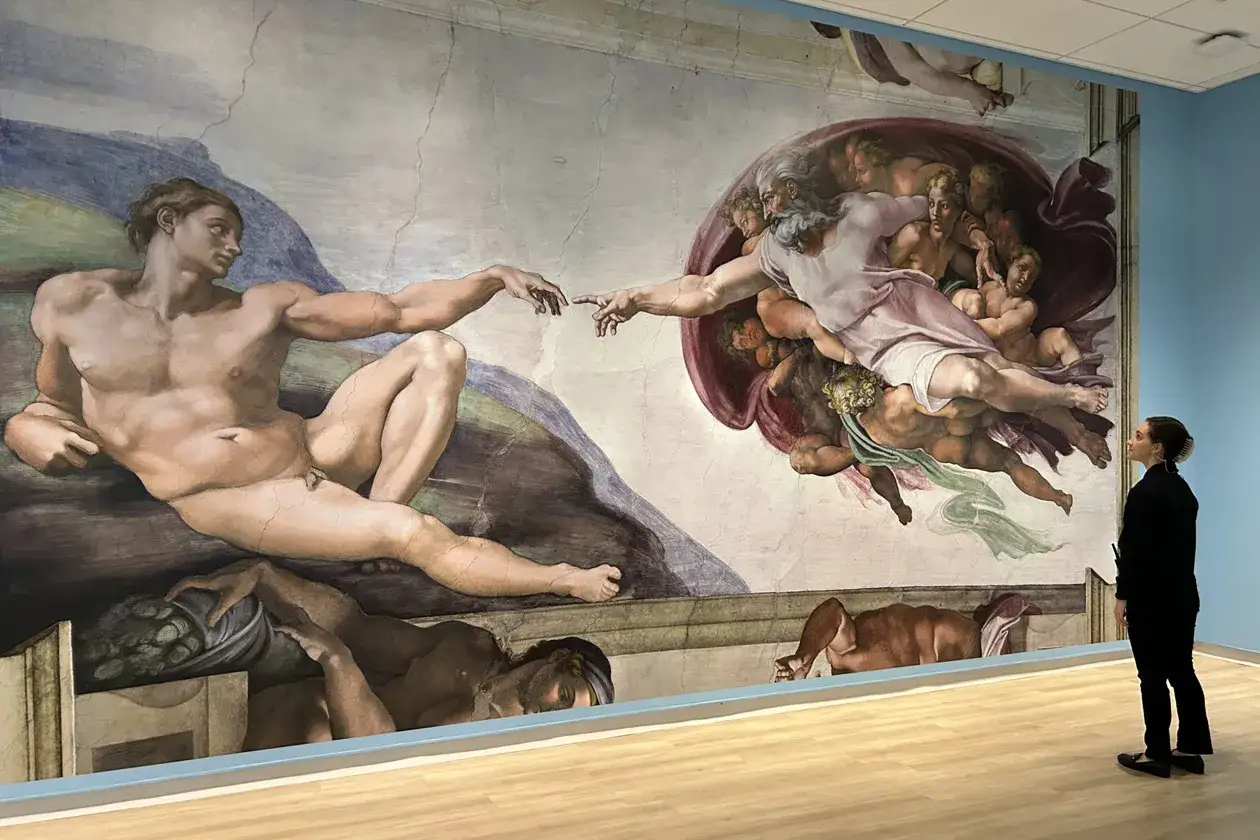 A woman gazes at Michelangelo's iconic history painting, 