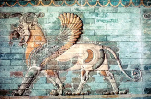 A winged lion with ram's horns, a magnificent example of ancient Iranian art, strides across a wall of glazed bricks.
